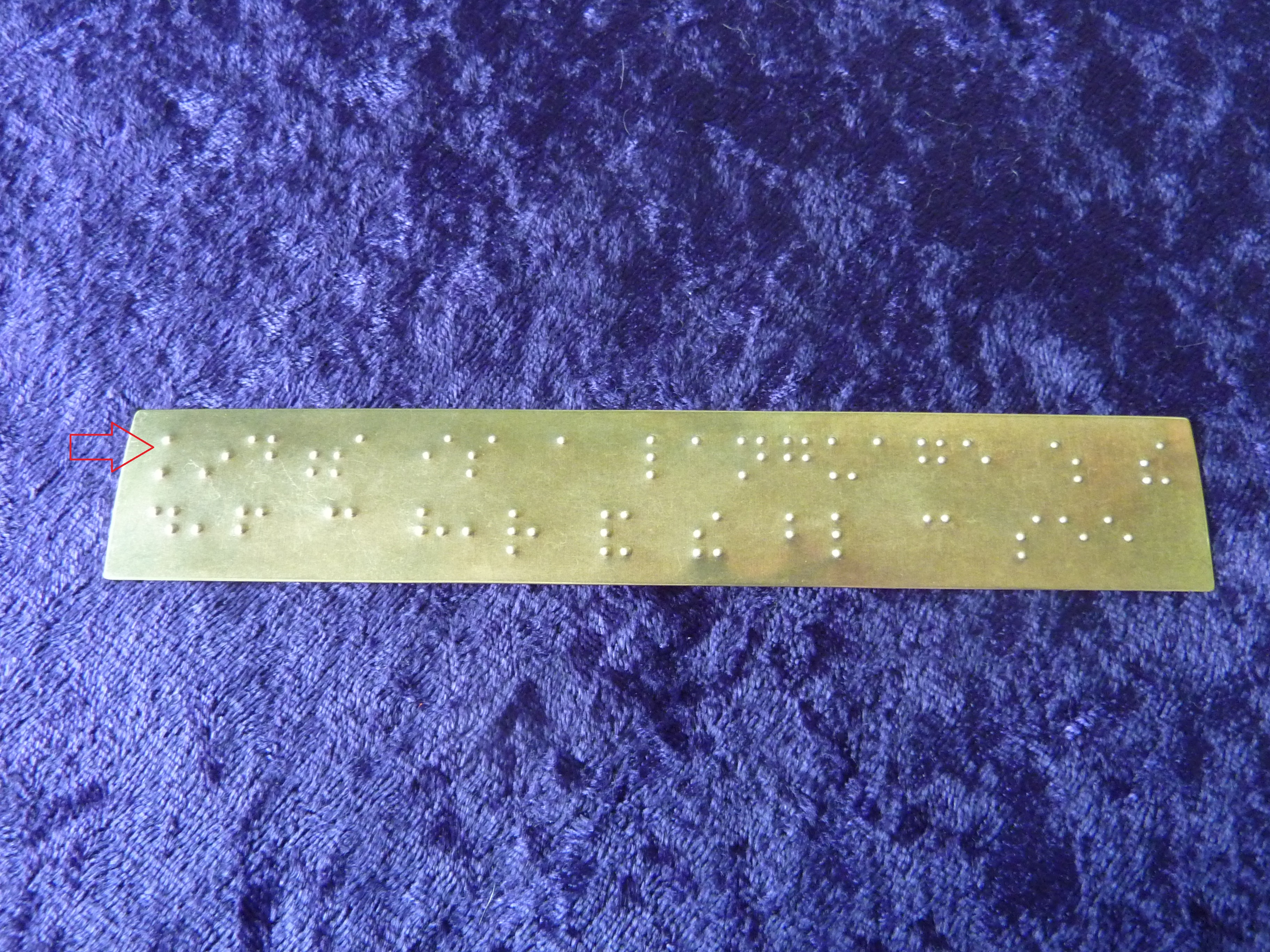 Photo of custom bookmark embossed in braille with quote by Mark Twain: "Kindness is a language which the deaf can hear and the blind can see."